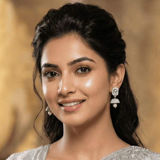 Woman wearing silver earrings with a blurred background